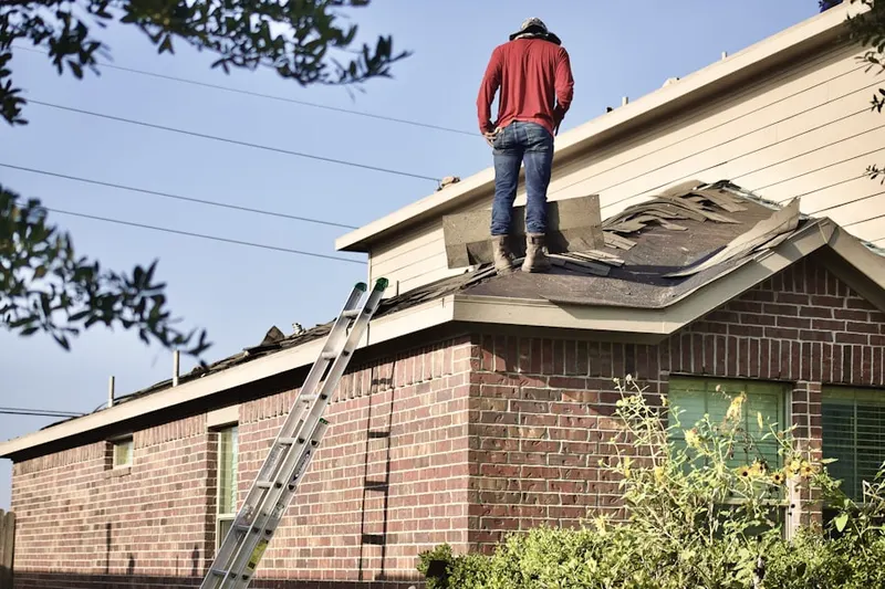 Professional roofer working on a residential roof in Sweet Home